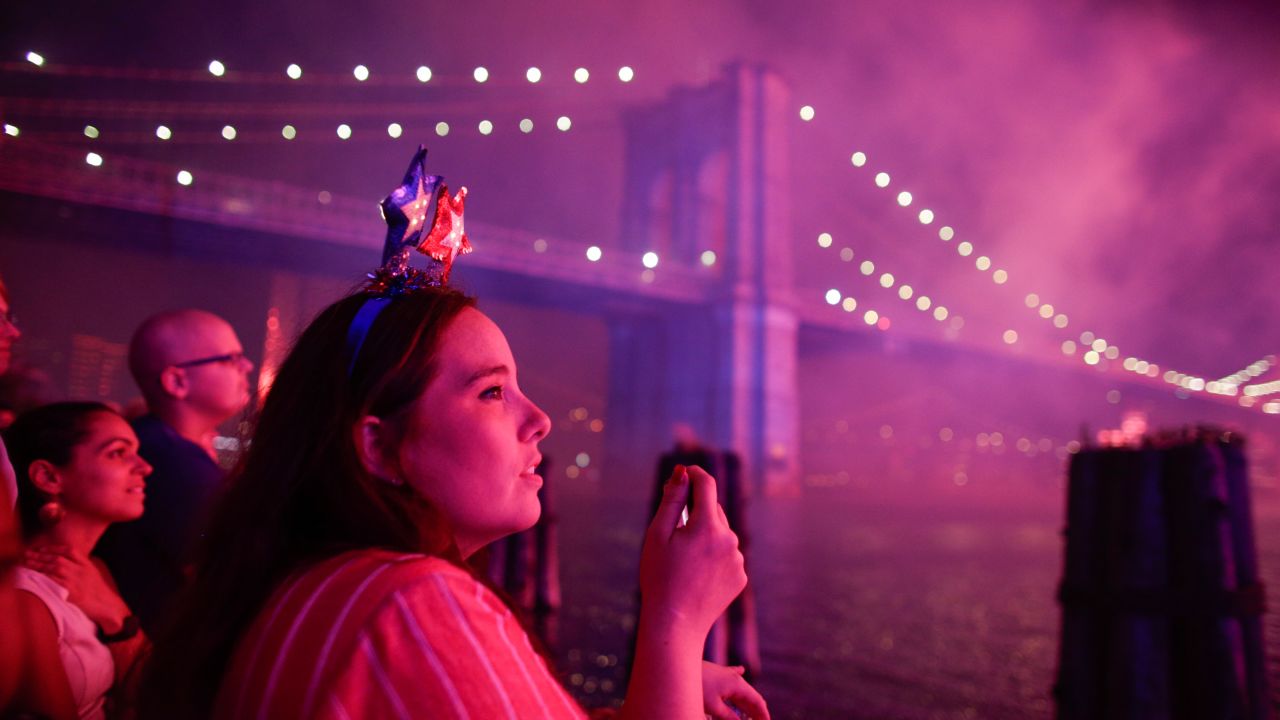 People watch fireworks light up the Brooklyn Bridge during the annual Macy's fireworks show on the East River from Manhattan July 4, 2019.