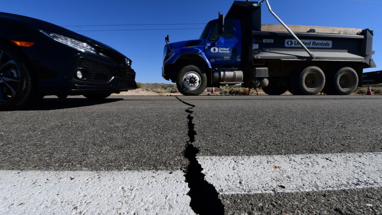 Vehicles drive over a crack on Highway 178 south of Trona, after a 6.4-magnitude earthquake hit in Ridgecrest, California, on July 4, 2019.