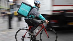 LONDON, ENGLAND - JULY 11:  A Deliveroo rider cycles through central London on July 11, 2017 in London, England. A recent government review looking at the 'Gig Economy', the 'Taylor Review' has suggested that all work in U.K. should be fair. Deliveroo's co-founder and CEO, Will Shu has said that his company will pay additional benefits to its 15,000 UK riders if the laws change.  (Photo by Dan Kitwood/Getty Images)