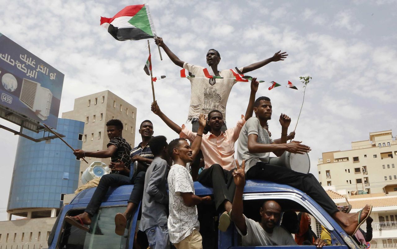 Sudanese protesters celebrate in the streets of the capital, Khartoum, after ruling generals and protest leaders announced they have reached an agreement on a new governing body Friday.