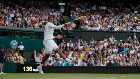 Nick Kyrgios fires a forehand against Rafael Nadal on Centre Court.