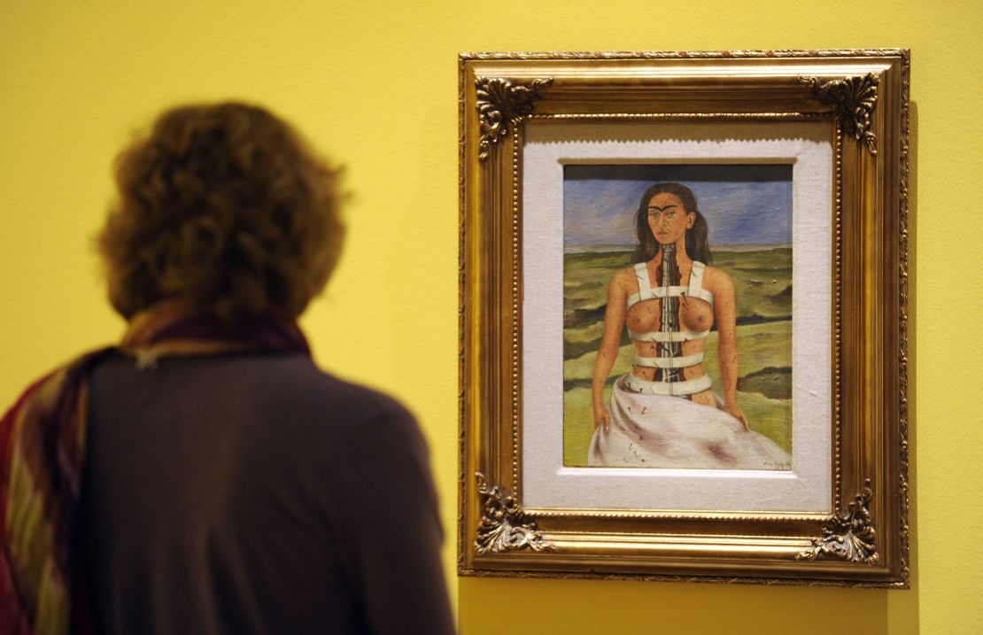 A visitor looks at the painting "The Broken Column" by Frida Kahlo at the Martin-Gropius-Bau museum in Berlin.