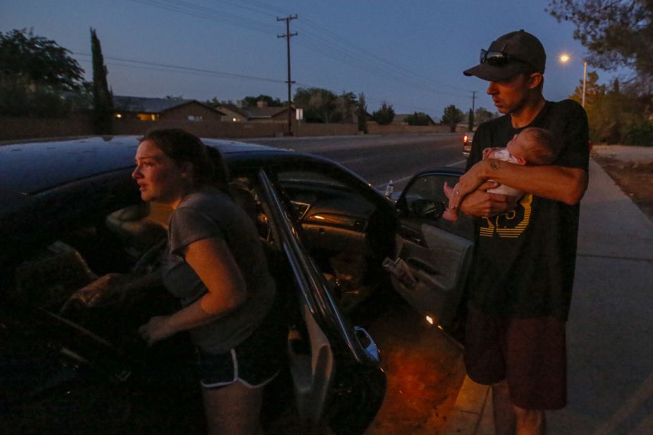Davia and Peyton Speed and their 1-month-old daughter Lillian get into their car for safety after the earthquake in Ridgecrest.