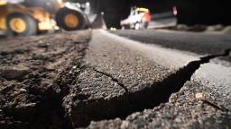 Highway workers repair a hole that opened in the road as a result of the July 5, 2019 earthquake, in Ridgecrest, California, about 150 miles (241km) north of Los Angeles, early in the morning on July 6, 2019. - Southern California was hit by its largest earthquake in two decades on July 5, a 7.1-magnitude tremor that rattled residents who were already reeling from another strong quake a day earlier. (Photo by Robyn Beck / AFP)        (Photo credit should read ROBYN BECK/AFP/Getty Images)