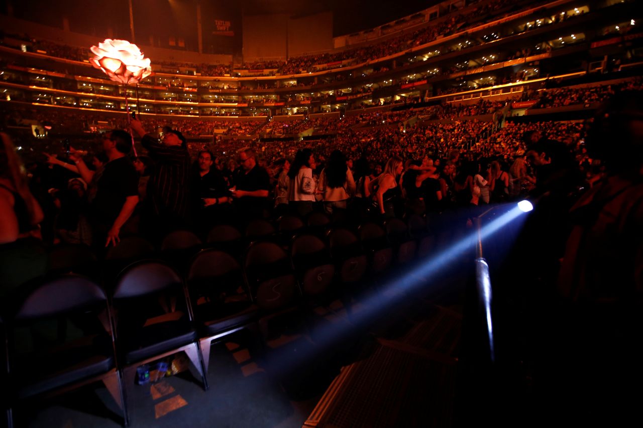 An usher uses a flashlight to clear the front row during an earthquake that struck before a Shawn Mendes concert at Staples Center in Los Angeles on Friday. 
