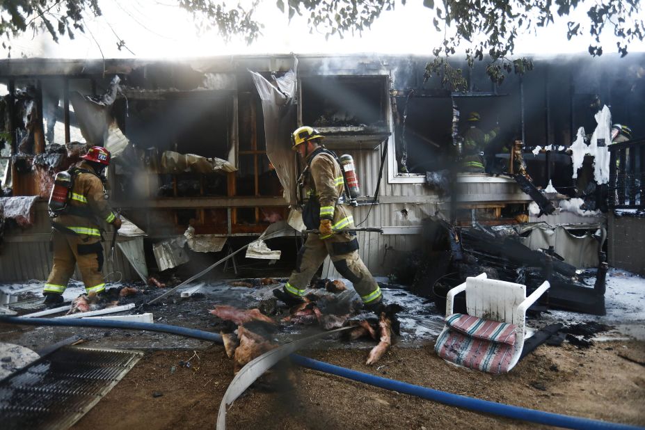 Firefighters work to put out a house fire the morning after a 7.1 magnitude earthquake struck in the area of Ridgecrest, California.