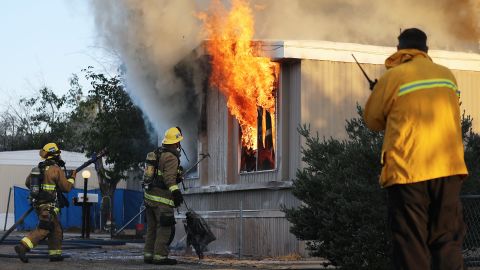 Firefighters battle a house fire on Saturday, July 6, 2019 in Ridgecrest, California, the morning after a 7.1 magnitude earthquake struck the area.