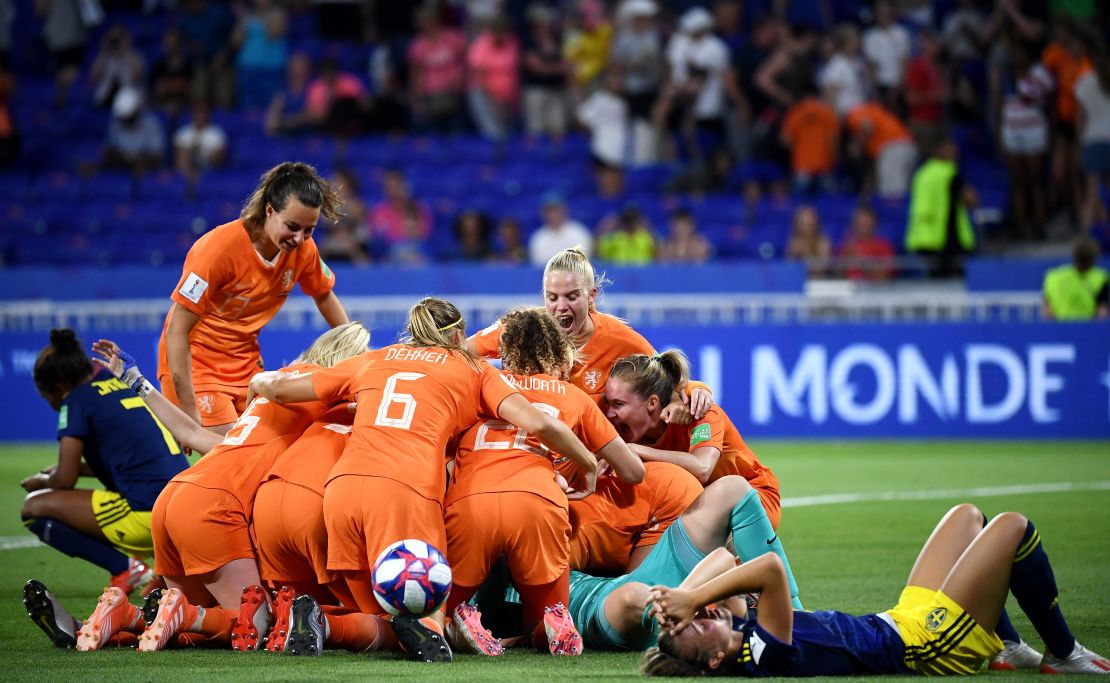 Netherlands players pile on top of each other after victory over Sweden. 