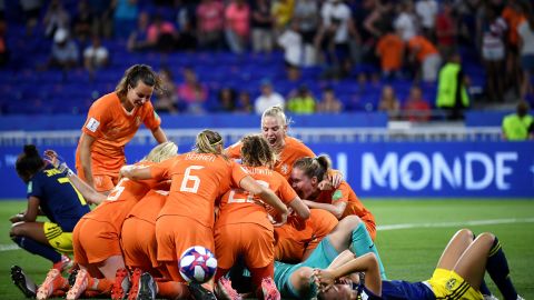 Netherlands players pile on top of each other after victory over Sweden. 