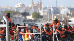 TOPSHOT - Migrants who were stuck on a ship since their rescue in the Mediterranean 10 days ago, arrive to disembark in Valletta, Malta on April 13, 2019 after four European countries agreed to take them in. - All 62 migrants on the Alan Kurdi ship will be disembarked and redistributed between Germany, France, Portugal and Luxembourg, Malta's prime minister Joseph Muscat announced on Twitter. (Photo by Matthew Mirabelli / AFP)        (Photo credit should read MATTHEW MIRABELLI/AFP/Getty Images)
