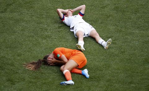 The Netherlands' Lieke Martens and the US' Kelley O'Hara lie on the field after a collision late in the first half. O'Hara had to be substituted at halftime.