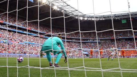 Megan Rapinoe scores her team's first goal from the penalty spot past Sari Van Veenendaal of the Netherlands.