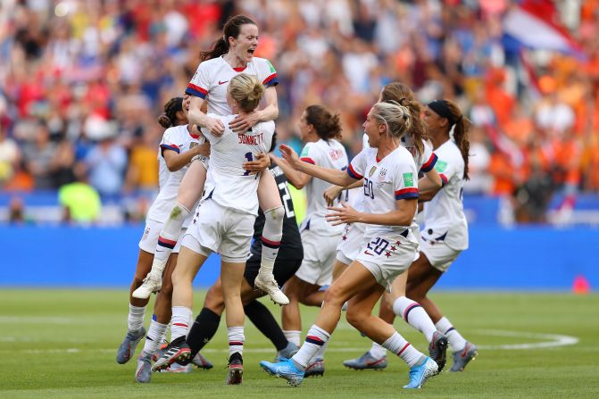 US players celebrate after the final whistle.