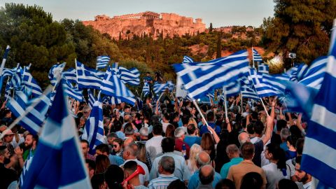 New Democracy supporters waved Greek flags at a rally for Mitsotakis in Athens.