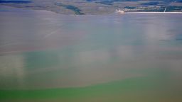 A toxic algae bloom can be seen from the air along the Mississippi coast on June 25, 2019