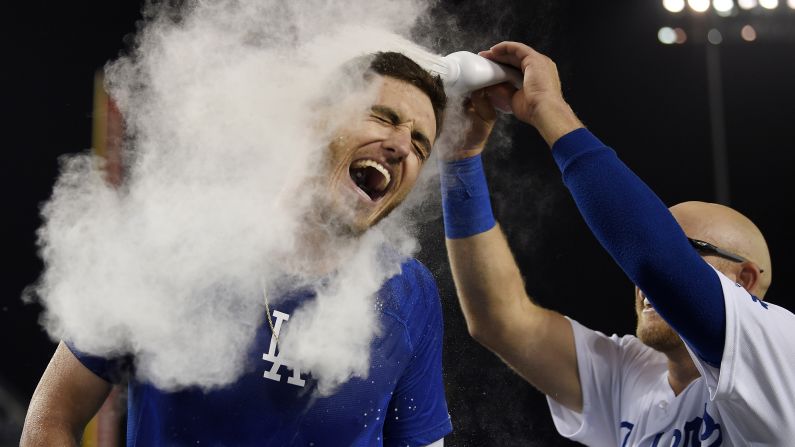 The Los Angeles Dodgers' Cody Bellinger, left, is doused with baby powder by teammate Matt Beaty after hitting a solo walk-off home run during the 10th inning of a baseball game against the Arizona Diamondbacks in Los Angeles on Wednesday, July 3. The Dodgers won 5-4.