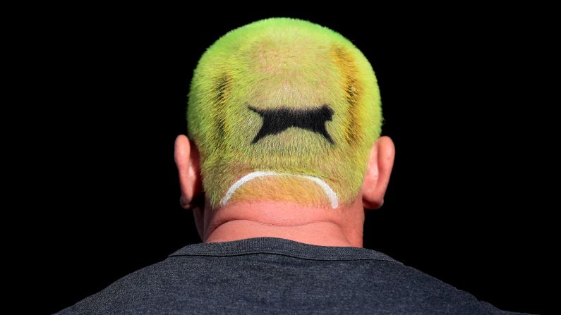 A tennis fan with hair dyed to resemble a Slazenger tennis ball attends Wimbledon in London, England, on Monday, July 1.