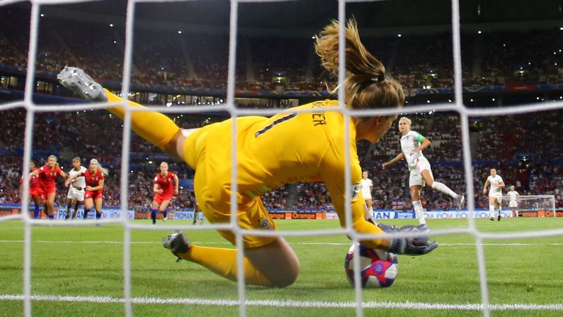 US goalkeeper Alyssa Naeher saves a penalty by England's Steph Houghton during their <a href="index.php?page=&url=https%3A%2F%2Fwww.cnn.com%2F2019%2F07%2F03%2Ffootball%2Fgallery%2Fuswnt-world-cup-2019%2Findex.html" target="_blank">Women's World Cup</a> semifinal match in Lyon, France, on Tuesday, July 2. The save preserved the Americans' 2-1 lead and helped them advance to the World Cup final.