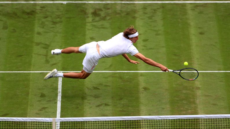 Alexander Zverev dives for the ball during his Wimbledon first round match against Jiri Vesely in London, England, on Monday, July 1.