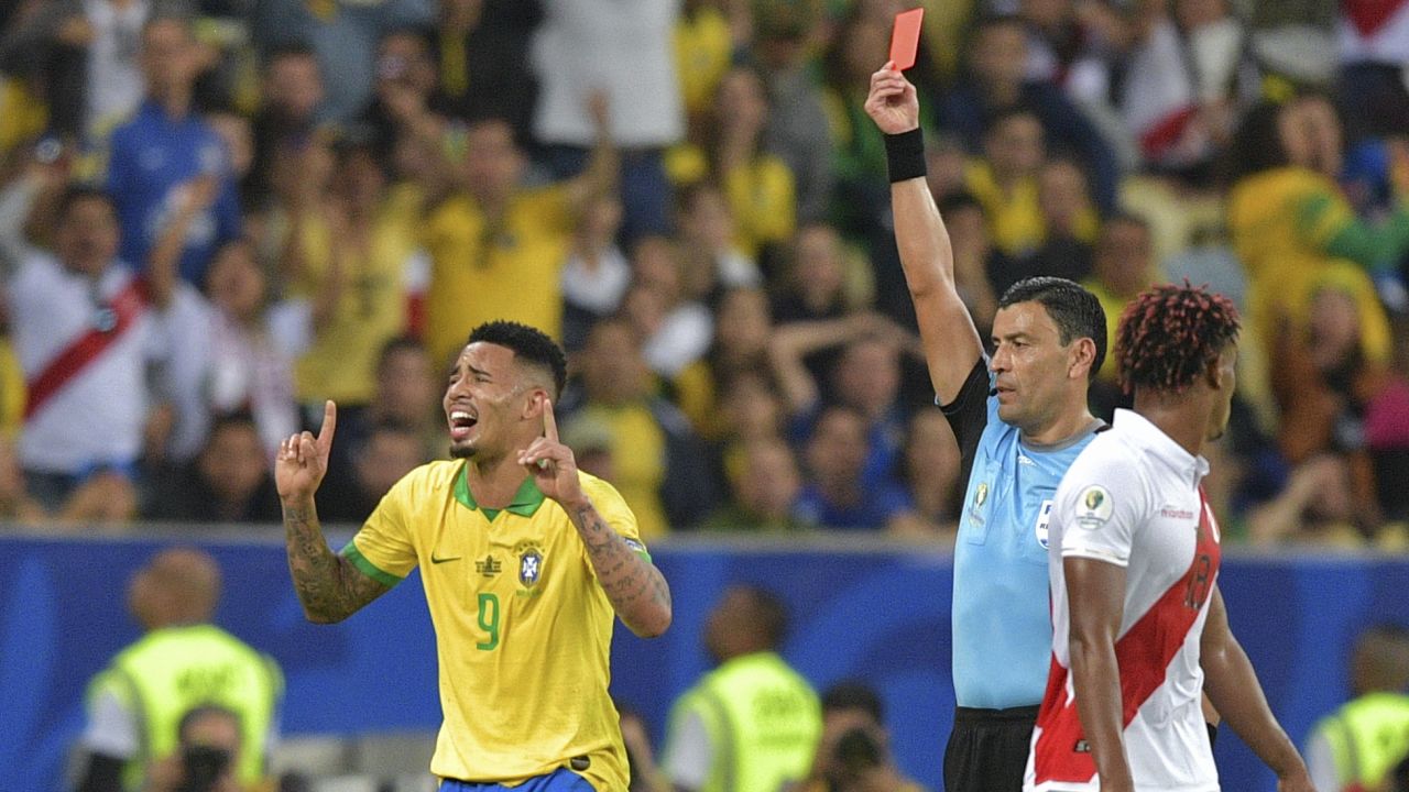 Chilean referee Roberto Tobar shows the red card to Brazil's Gabriel Jesus.