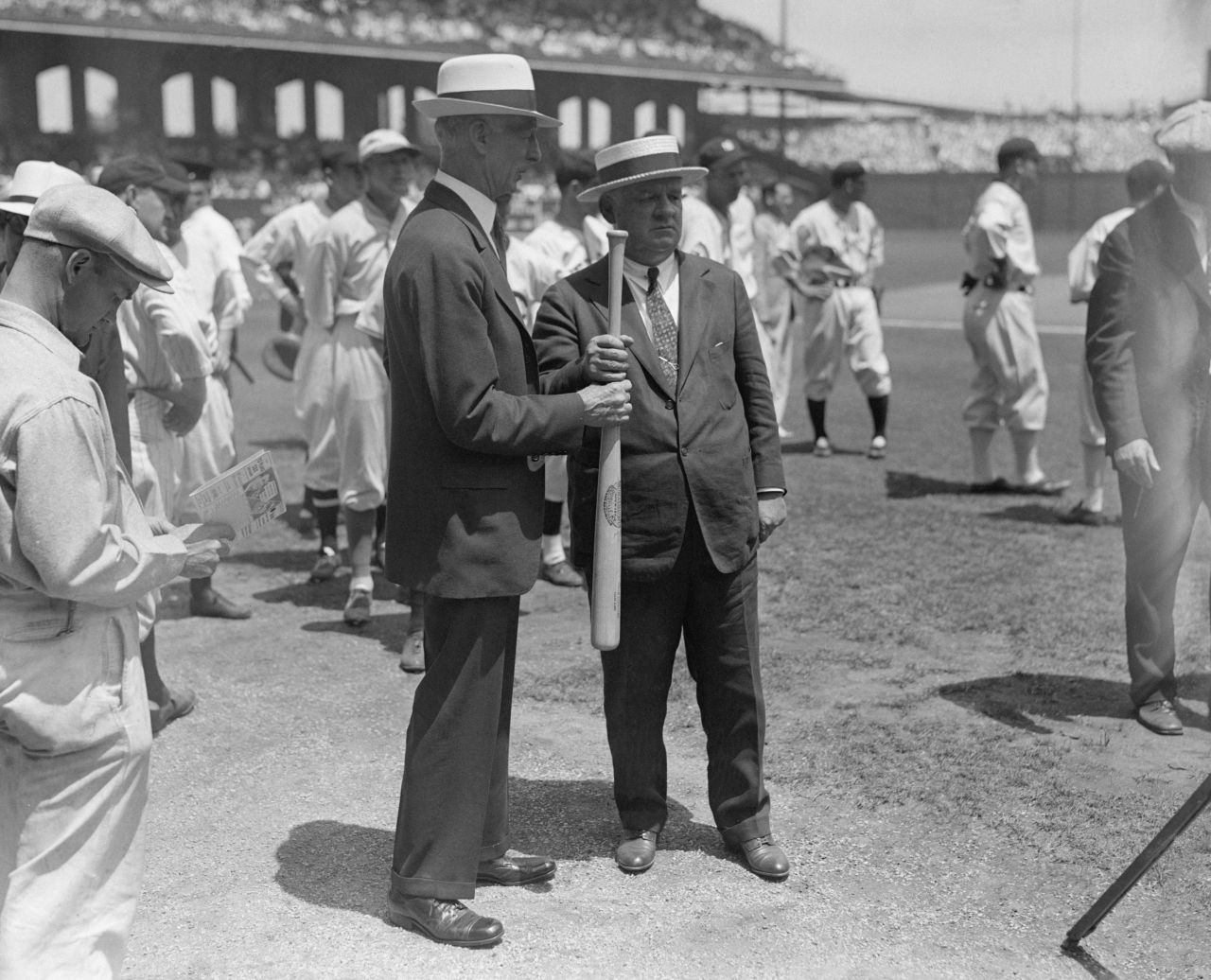 American League manager Connie Mack, left, and National League manager John McGraw play a sandlot "hand-over-hand" game to determine which team would bat first in the 1933 All-Star Game.
