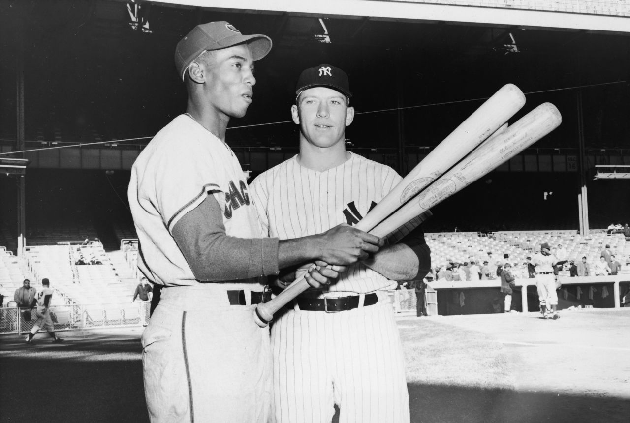 Future Hall of Famers Ernie Banks, left, and Mickey Mantle talk before the All-Star Game in Baltimore in 1958. That year, both were leading their respective leagues in home runs.