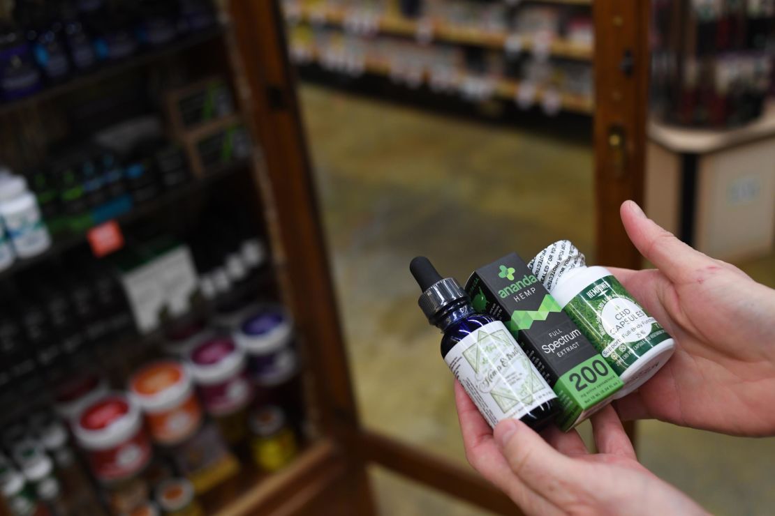 Sarah Shebanek, a wellness buyer for  Alfalfa's, holds some of the CBD oil supplements sold in the Colorado store.