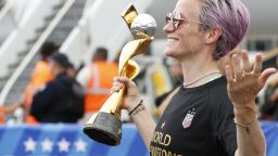 United States women's soccer team member Megan Rapinoe holds the Women's World Cup trophy as she poses for the media after arriving with the rest of the team at Newark Liberty International Airport, Monday, July 8, 2019, in Newark, N.J. (AP Photo/Kathy Willens)