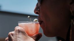 NEW YORK, NY - JUNE 12:  A woman sips a drink made from Dewars Scotch whiskey at Bar Convent Brooklyn, an international bar & beverage trade show at the Brooklyn Expo Center on June 12, 2018 in the Brooklyn borough of New York City. An extension of Bar Convent Berlin, the trade show draws both premium brands and craft spirit brands for two days of discussions on new trends, techniques and products in the domestic and international markets. Attendees to the show can also participate in taste forums, demonstrations, keynote addresses and panel discussions with leading industry experts.  (Photo by Spencer Platt/Getty Images)