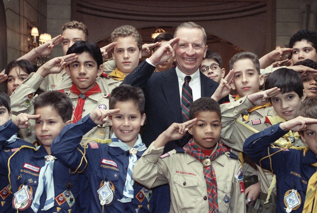 Perot, an Eagle Scout, gives the Boy Scout salute at a luncheon in New York in June 1990. He was receiving a Boy Scouts Award for Courage.
