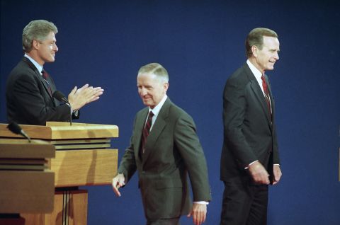 Perot walks toward his position on stage before debating Bill Clinton, left, and US President George H.W. Bush in October 1992. Perot was running as an independent.