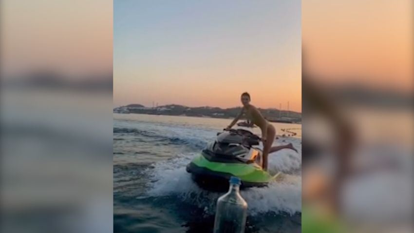 Kendall Jenner is among the many celebrities taking on the bottle cap challenge, twisting the cap off on a jet ski in Greece.