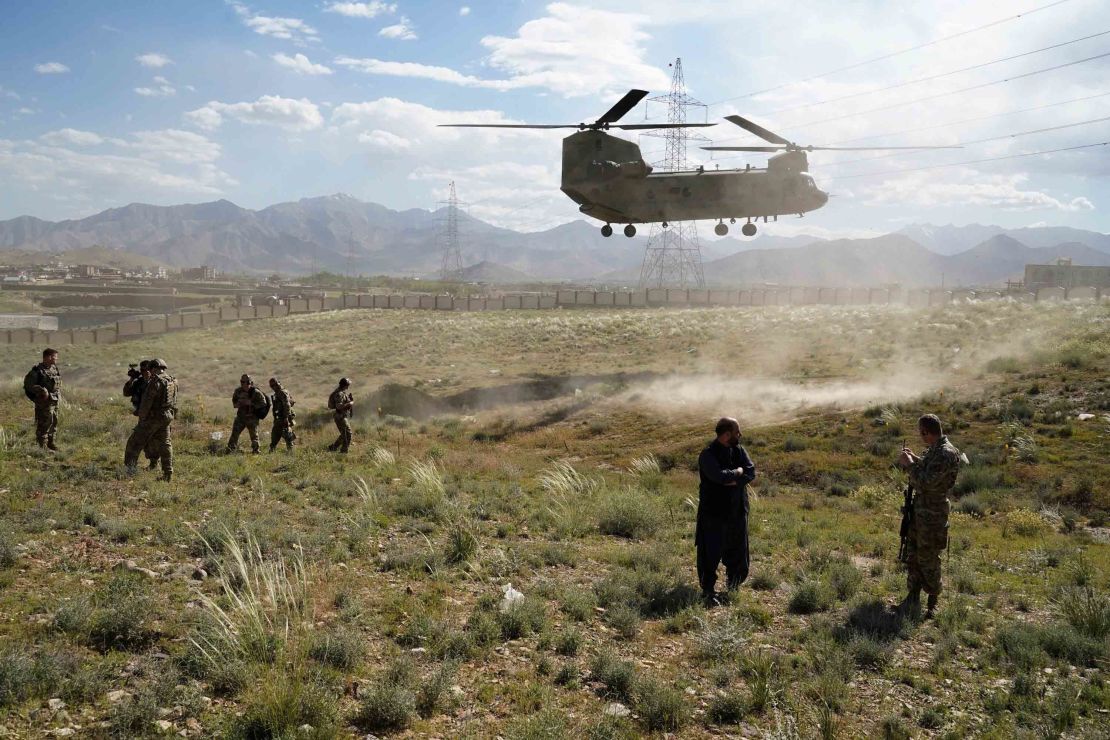 In this photo taken on June 6, 2019, a US military Chinook helicopter lands on a field outside the governor's palace during a visit by the commander of US and NATO forces in Afghanistan, General Scott Miller, and Asadullah Khalid, acting minister of defense of Afghanistan, in Maidan Shar, capital of Wardak province.