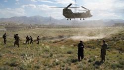 In this photo taken on June 6, 2019, a US military Chinook helicopter lands on a field outside the governor's palace during a visit by the commander of US and NATO forces in Afghanistan, General Scott Miller, and Asadullah Khalid, acting minister of defense of Afghanistan, in Maidan Shar, capital of Wardak province. - A skinny tangle of razor wire snakes across the entrance to the Afghan army checkpoint, the only obvious barrier separating the soldiers inside from any Taliban fighters that might be nearby. (Photo by THOMAS WATKINS / AFP) / To go with 'AFGHANISTAN-CONFLICT-MILITARY-US,FOCUS' by Thomas WATKINS        (Photo credit should read THOMAS WATKINS/AFP/Getty Images)