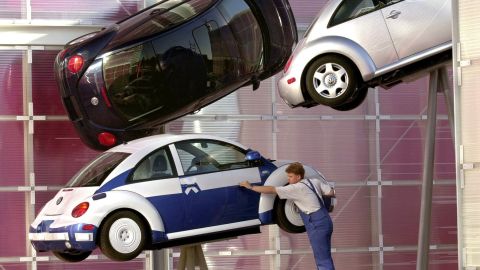 Preparing for an expo in Hanover, Germany, in 2000, a worker carefully removes the protective foil from a New Beetle.