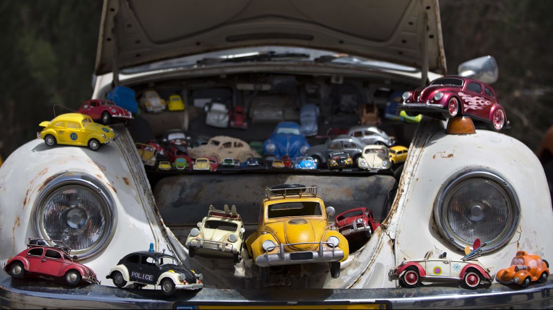With its playful shape, the Beetle has inspired endless numbers of miniature toy versions. Here, some of them are displayed inside the front trunk, or "frunk," of an old Beetle.