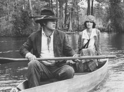 Actors Rip Torn and Mary Steenburgen in a rowing boat, in a scene from the movie 'Cross Creek', 1983.