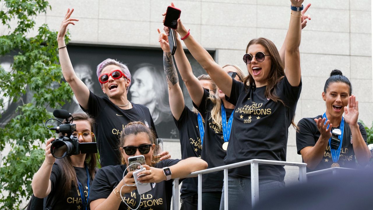 Rapinoe and Morgan, along with other members of the US women's soccer team, stand on a float before being honored with a ticker tape parade.
