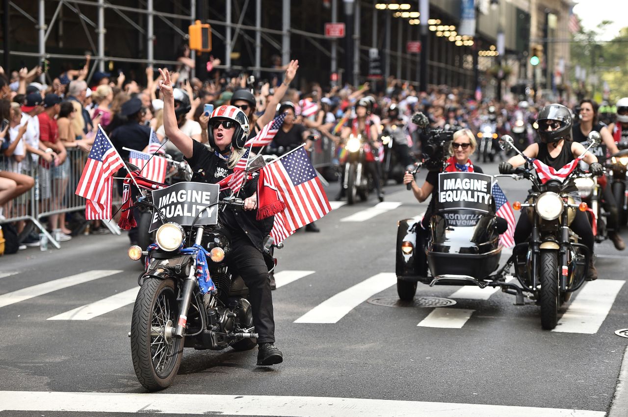 Motorcyclists celebrate with the US Women's Soccer team. 