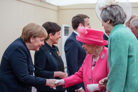 Britain's Queen Elizabeth II, accompanied by Prime Minister Theresa May, greets Merkel in Portsmouth, England, in June 2019. It was ahead of an event marking the 75th anniversary of the D-Day invasion.