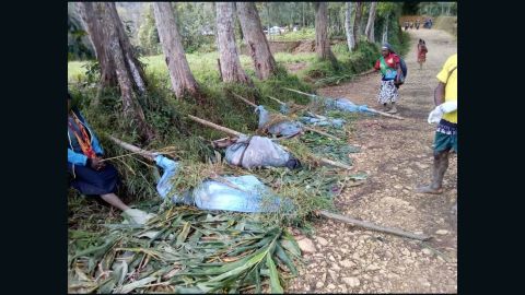 A Facebook post from local officials showed bodies wrapped in blue bags as they were prepared for transport out of the village. 