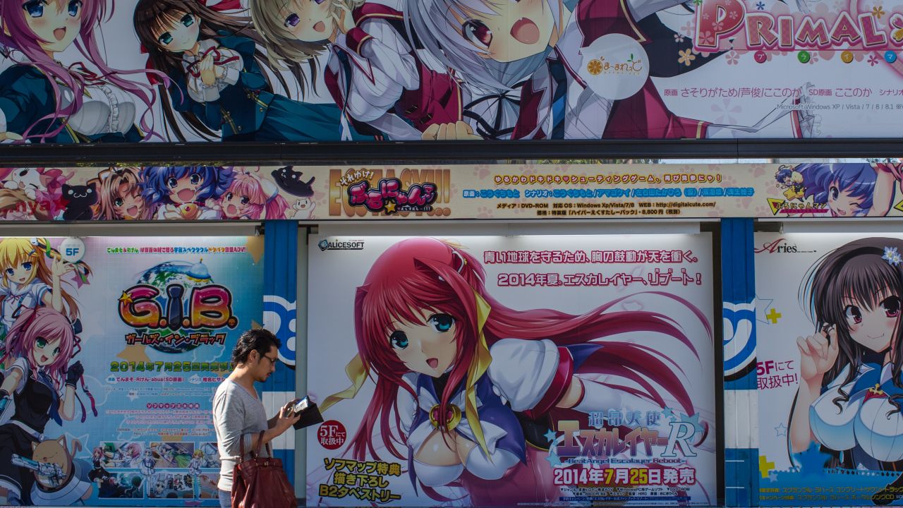 A man walks past the outside of a store selling anime and manga in Akihabara on June 19, 2014 in Tokyo, Japan.