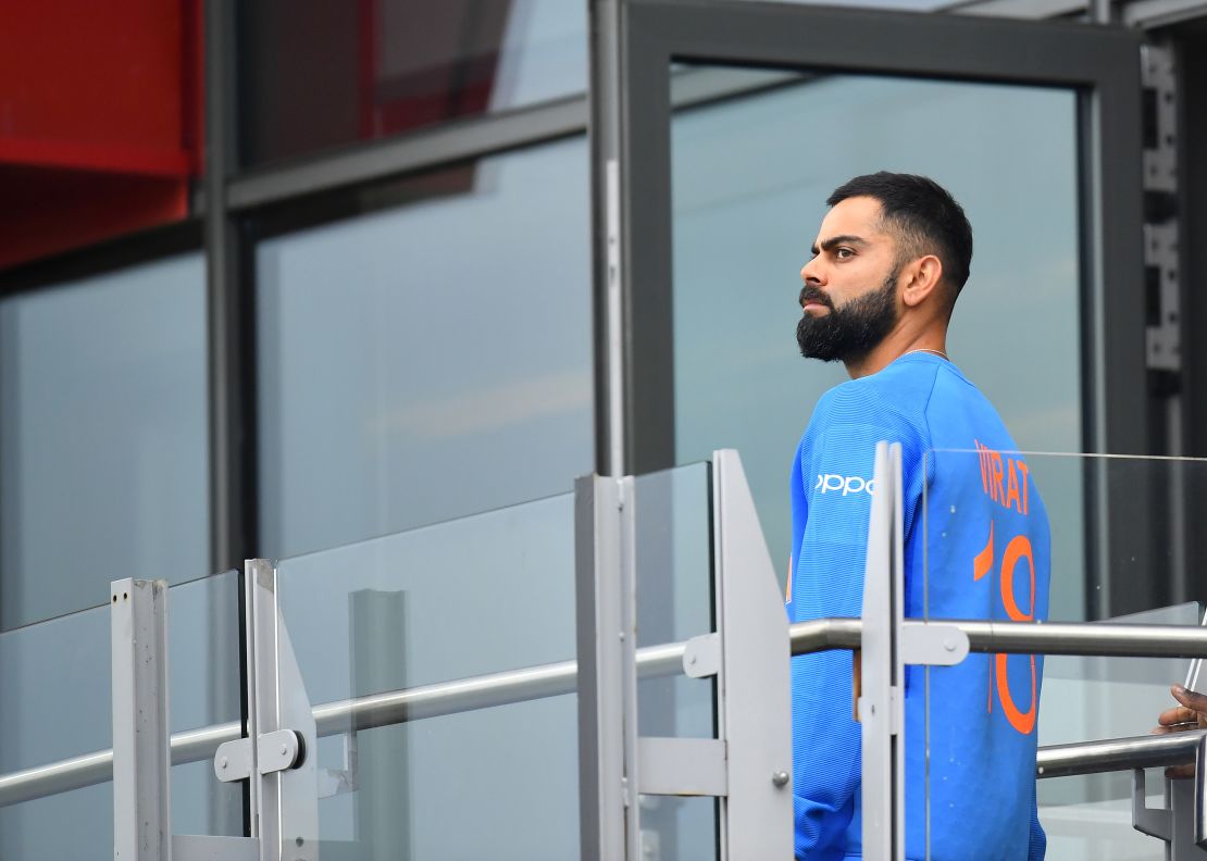 Virat Kohli walks back to the changing room after losing the semifinal.