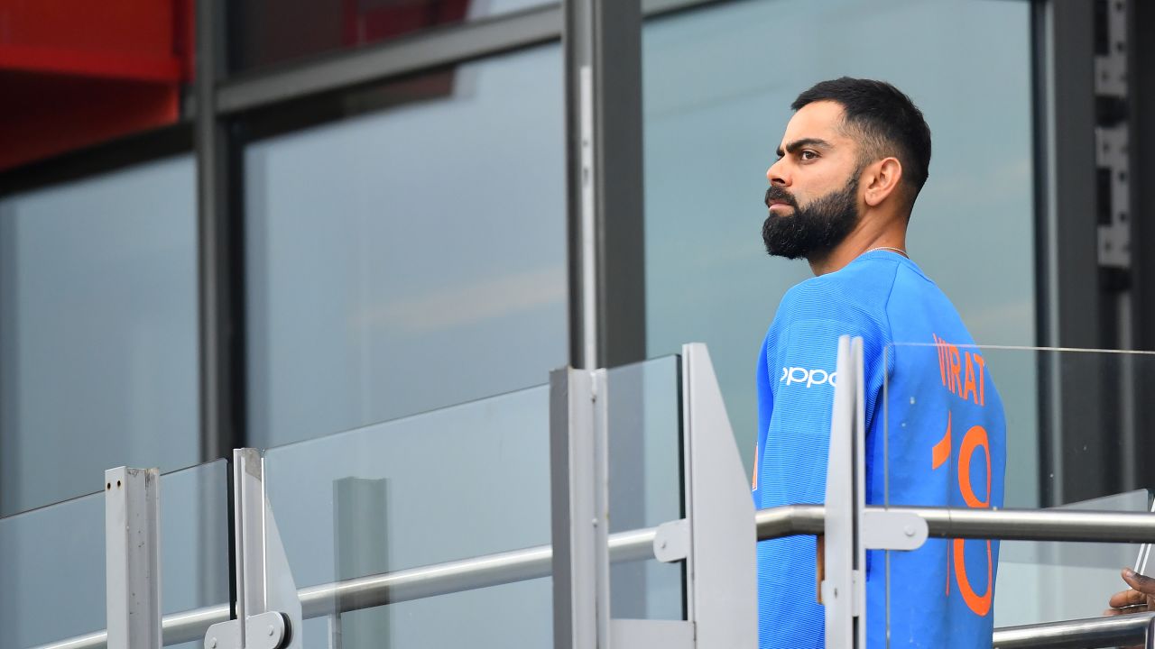 Virat Kohli walks back to the changing room after losing the semifinal.