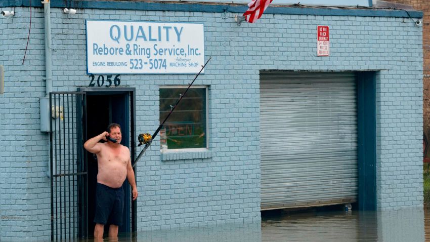 David Fox makes a call from his businest in New Orleans after flooding in New Orleans Wednesday, July 10, 2019.
