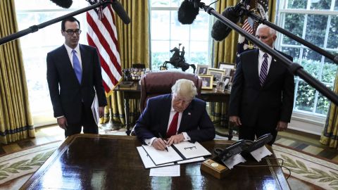 President Trump signs an executive order imposing fresh sanctions on Iran in the Oval Office on June 24.