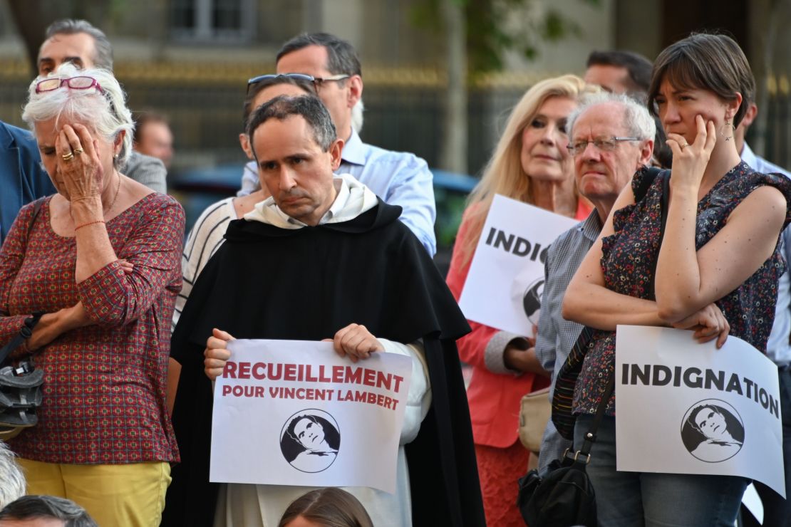People pray for Lambert in front of the Saint-Sulpice church in Paris on July 10, 2019.