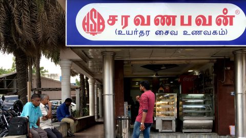 People outside a restaurant of the popular Saravana Bhavan food chain in Chennai in June 2019.
