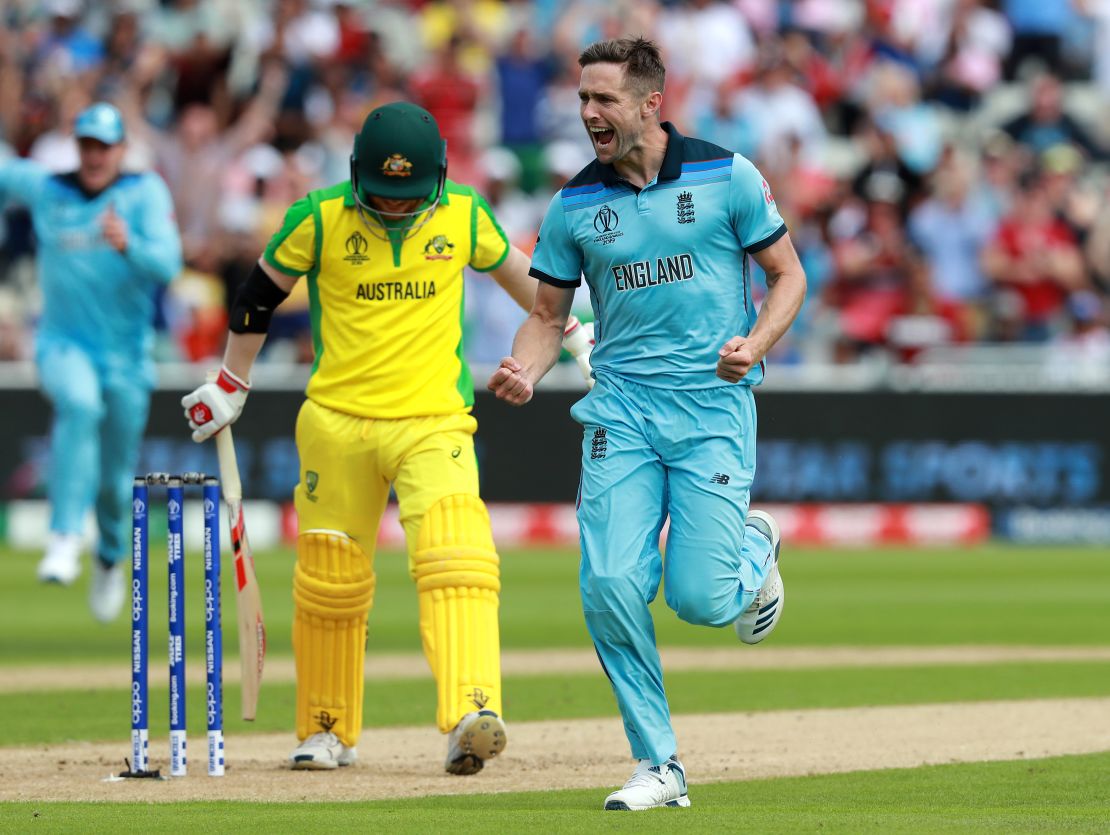 Chris Woakes of England celebrates taking the wicket of David Warner.