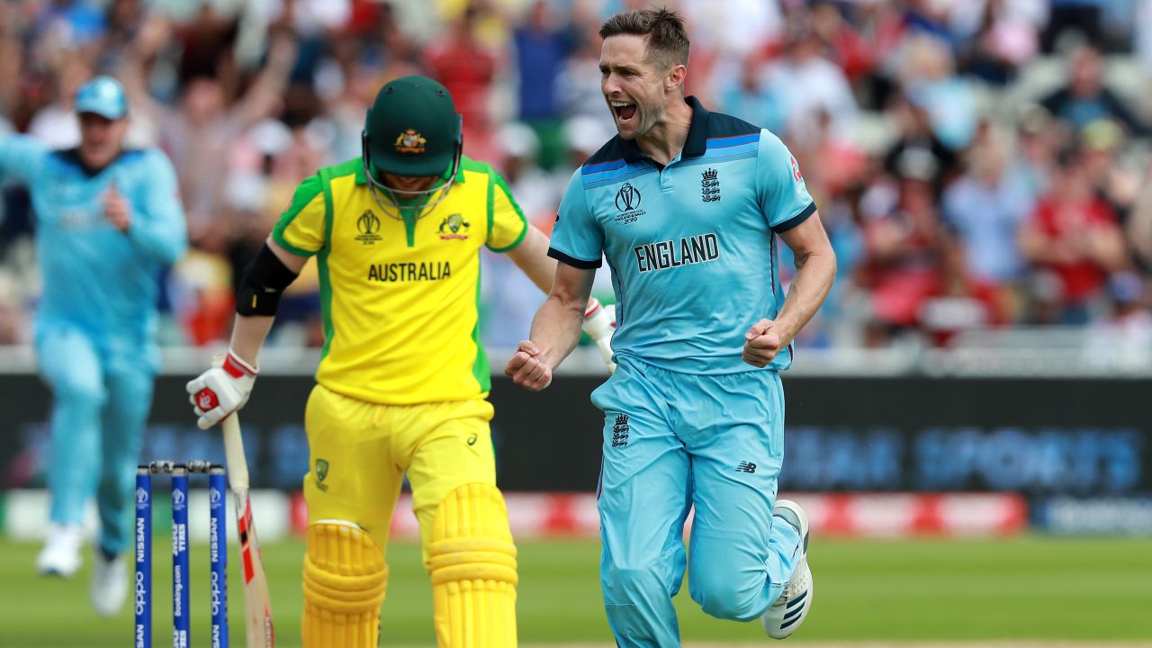 England's Chris Woakes celebrates taking the wicket of David Warner of Australia.